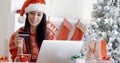 Smiling woman doing online Christmas shopping