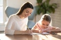 Smiling woman drawing colorful pencils with adorable little daughter Royalty Free Stock Photo