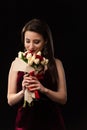 Smiling woman in dress smelling bouquet Royalty Free Stock Photo