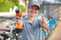 smiling woman with drill machine showing thumb up Royalty Free Stock Photo