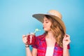 Smiling woman drink red juice. studio portrait with blue background and copy space Royalty Free Stock Photo