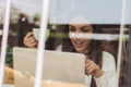 Smiling woman drinking coffee and surfing on internet. Cafe wind Royalty Free Stock Photo