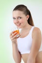 Smiling woman drinking orange juice vitamin