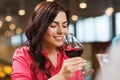 Smiling woman drinking red wine at restaurant Royalty Free Stock Photo