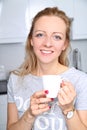 Smiling woman drinking a warm drink