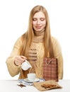 Smiling woman drinks coffee with milk and cinnamon