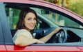 Smiling woman driver behind a wheel red car Royalty Free Stock Photo