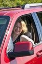 Smiling woman drives a car