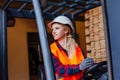 Smiling woman driving forklift truck at the warehouse Royalty Free Stock Photo