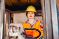 Smiling woman driving forklift truck at the warehouse Royalty Free Stock Photo