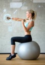 Smiling woman with dumbbells and exercise ball Royalty Free Stock Photo