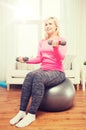 Smiling woman with dumbbells exercising at home Royalty Free Stock Photo