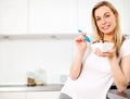 Smiling woman eating breakfast Royalty Free Stock Photo
