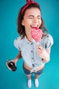 Smiling woman eating candy holding aerated sweet water.