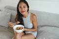 Smiling woman eating healthy breakfast at home in morning Royalty Free Stock Photo