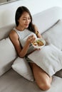 Smiling woman eating healthy breakfast at home in morning Royalty Free Stock Photo