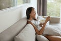 Smiling woman eating healthy breakfast at home in morning Royalty Free Stock Photo