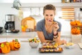 Smiling woman eating trick or treat halloween candy Royalty Free Stock Photo