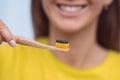 Smiling woman with eco friendly bamboo toothbrush with black charcoal toothpaste Royalty Free Stock Photo