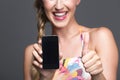 Smiling woman endorsing her smartphone