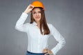 Smiling woman engineer builder worker touching her protect helmet. Royalty Free Stock Photo