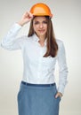 Smiling woman engineer builder worker touching her protect helmet. Royalty Free Stock Photo