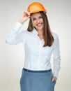 Smiling woman engineer builder worker touching her protect helmet. Royalty Free Stock Photo