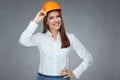 Smiling woman engineer builder worker touching her protect helmet. Royalty Free Stock Photo