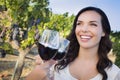 Smiling Woman Enjoying Glass of Wine in Vineyard With Friends Royalty Free Stock Photo