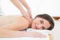 Smiling woman enjoying shoulder massage at beauty spa Royalty Free Stock Photo