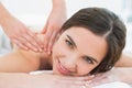 Smiling woman enjoying shoulder massage at beauty spa Royalty Free Stock Photo