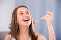 Smiling woman is enjoying tasty green salad Royalty Free Stock Photo