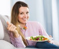 Smiling woman enjoying to eat tasty green salad Royalty Free Stock Photo
