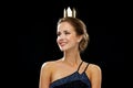 Smiling woman in evening dress wearing crown