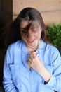 Smiling woman with everyday makeup and wearing jeans shirt.