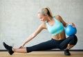 Smiling woman with exercise ball in gym Royalty Free Stock Photo