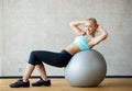 Smiling woman with exercise ball in gym Royalty Free Stock Photo