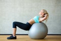 Smiling woman with exercise ball in gym Royalty Free Stock Photo