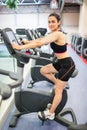 Smiling woman on the exercise bike Royalty Free Stock Photo