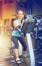 Smiling woman exercising on exercise bike in gym Royalty Free Stock Photo