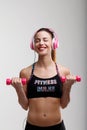 Smiling woman, eyes closed, lifting weights
