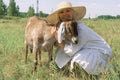 A smiling woman farmer hugs a Nubian goat. Royalty Free Stock Photo