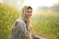 Smiling woman farmer in rapeseed agricultural field Royalty Free Stock Photo