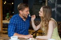 Smiling woman feeding man while sitting at table Royalty Free Stock Photo