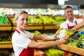 Smiling woman filling vegetables boxes