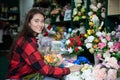 Smiling woman florist small business flower shop owner and Young florist examining flowers at the shop Royalty Free Stock Photo