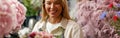 Smiling woman flower shop owner in apron looking on bouquet of flowers at florist store Royalty Free Stock Photo