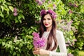 Smiling woman with flowers outdoors. Beautiful brunette girl Royalty Free Stock Photo