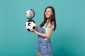 Smiling woman football fan support favorite team with soccer ball, Earth world globe isolated on blue turquoise