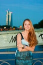 Smiling woman in front of urban night view